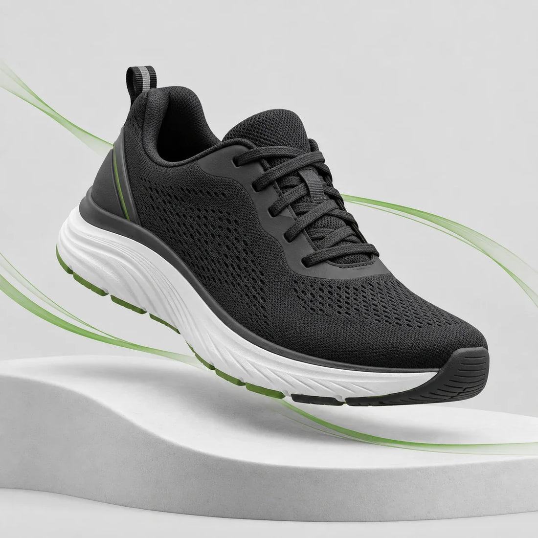 Black comfort walking shoe with green motion lines on an ORTHOFLEX light grey studio background
